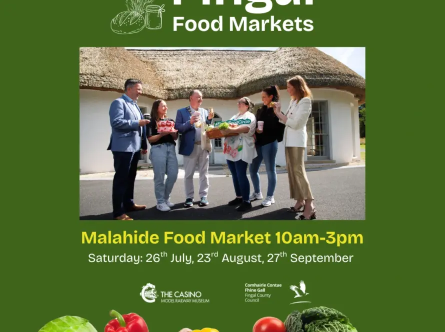 A group of people stand outside a thatched building, holding baskets of fresh produce, beneath the text "Fingal Food Markets." The Malahide Model Railway Museum welcome is featured alongside market dates. Fresh vegetables are displayed at the bottom.